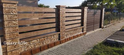 Gard din beton gri cu șipci antracit, de-a lungul străzii